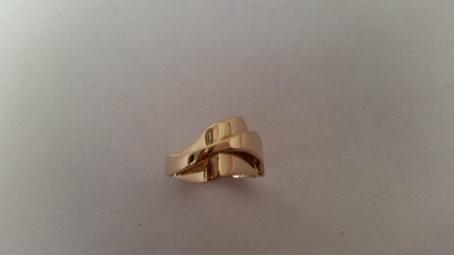 A gold ring with a smooth, criss-crossing design.